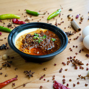 Mian dish with pepper and eggs around